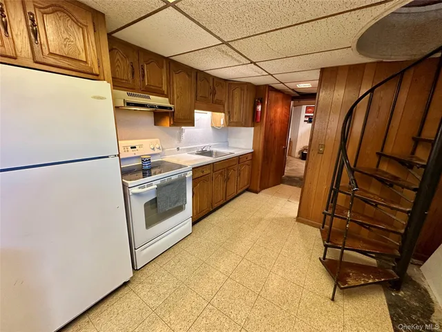 a kitchen with cabinets and white appliances