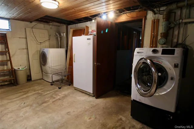 a view of a storage and utility room with washer and dryer