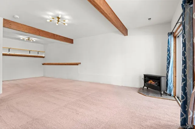 a view of empty room with a fireplace