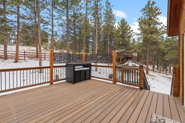 a view of a patio with wooden floor and fence
