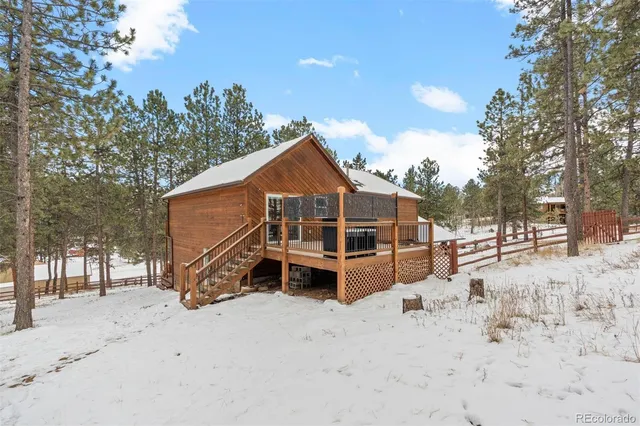 a view of a house with a yard covered in snow