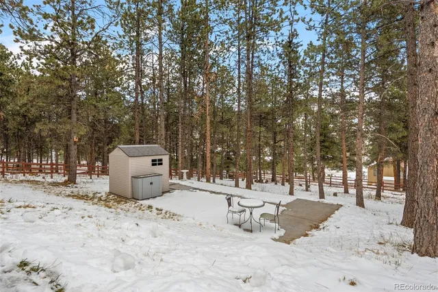 a white house that has a tree in front of it