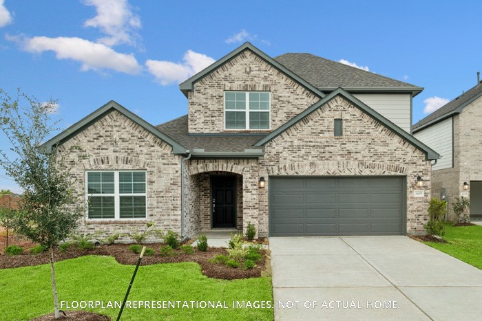 2127 Lone Bronco Boulevard Rosenberg, TX 77471 - Photo 4 of 16 a front view of a house with a yard and garage