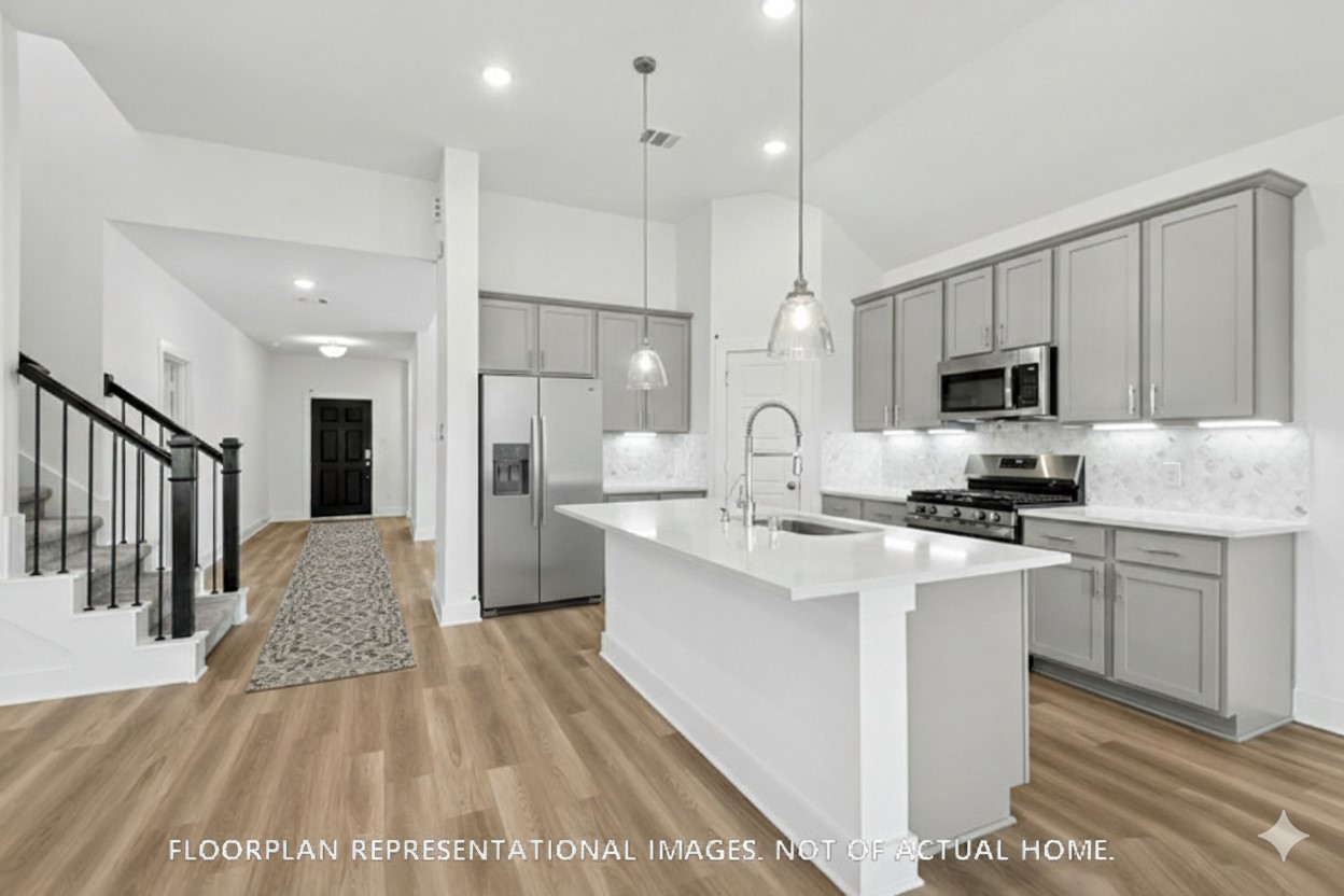 2127 Lone Bronco Boulevard Rosenberg, TX 77471 - Photo 6 of 16 a large kitchen with kitchen island a sink stainless steel appliances and cabinets