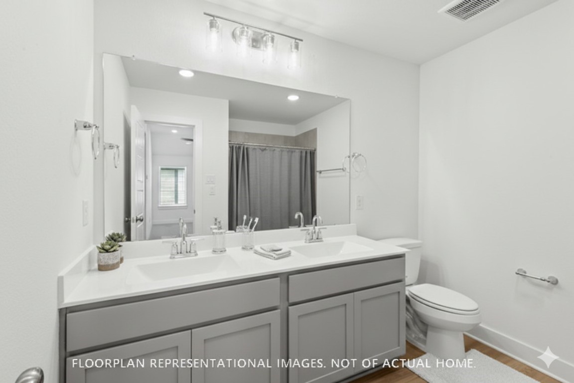 2127 Lone Bronco Boulevard Rosenberg, TX 77471 - Photo 9 of 16 a bathroom with a sink toilet and mirror