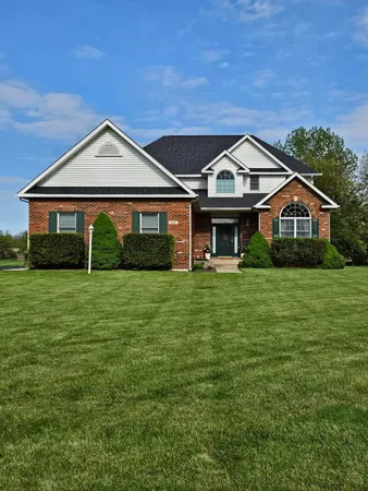 a front view of house with yard and green space