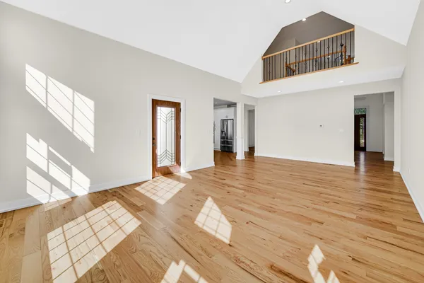 a large kitchen with stainless steel appliances kitchen island a large counter top and a wooden floors