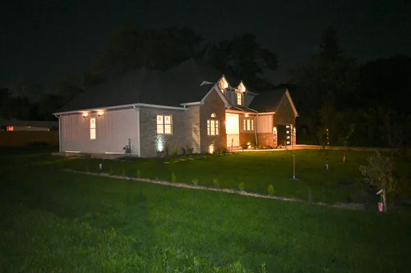a front view of a house with a garden