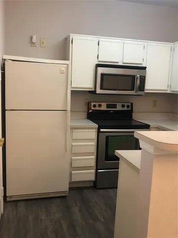 a kitchen with a refrigerator and a stove
