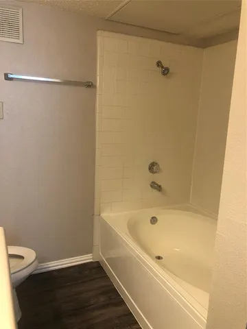 a bathroom with a bathtub and a toilet