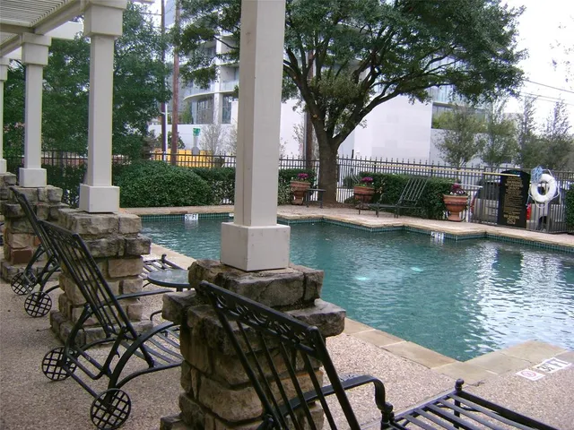 a view of house with backyard outdoor seating and lake view