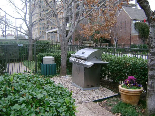 a front view of a house with a garden and fountain