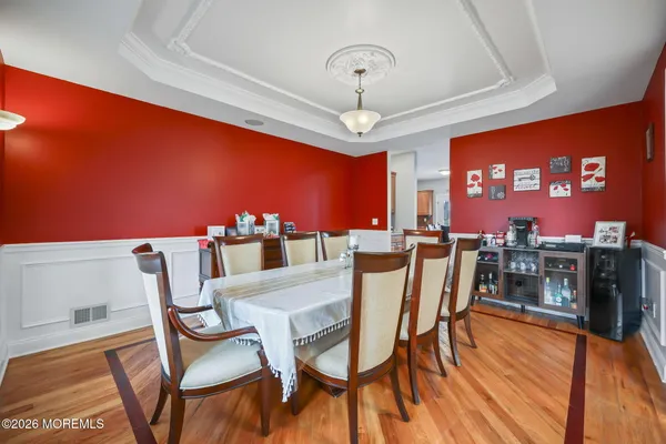a bed room with a bed television and a large window