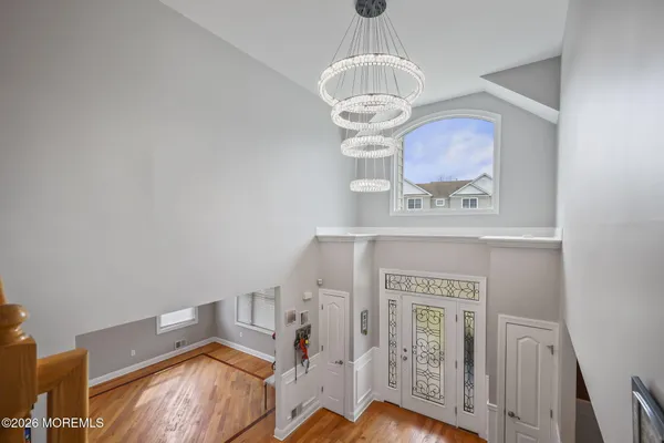 a view of entryway and hall with wooden floor