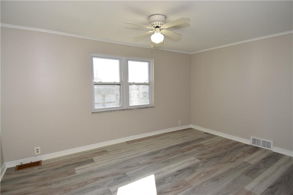 420 Jefferson Street Rochester, PA 15074 - Photo 12 of 19 wooden floor in an empty room with a window