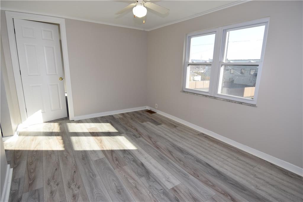 420 Jefferson Street Rochester, PA 15074 - Photo 13 of 19 an empty room with wooden floor and windows