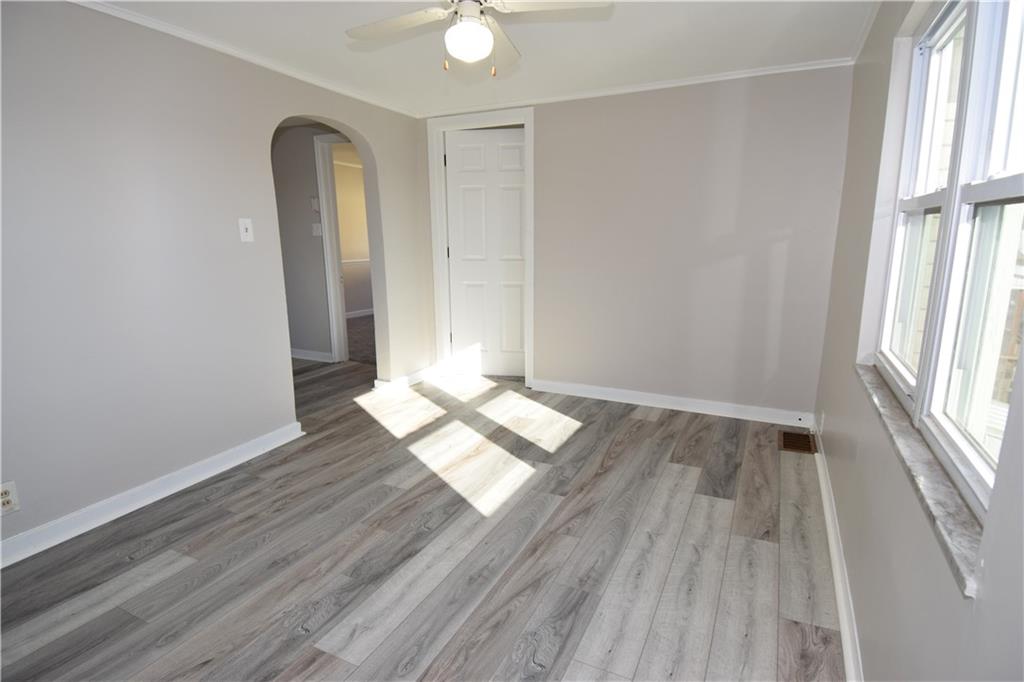 420 Jefferson Street Rochester, PA 15074 - Photo 6 of 19 an empty room with wooden floor and windows