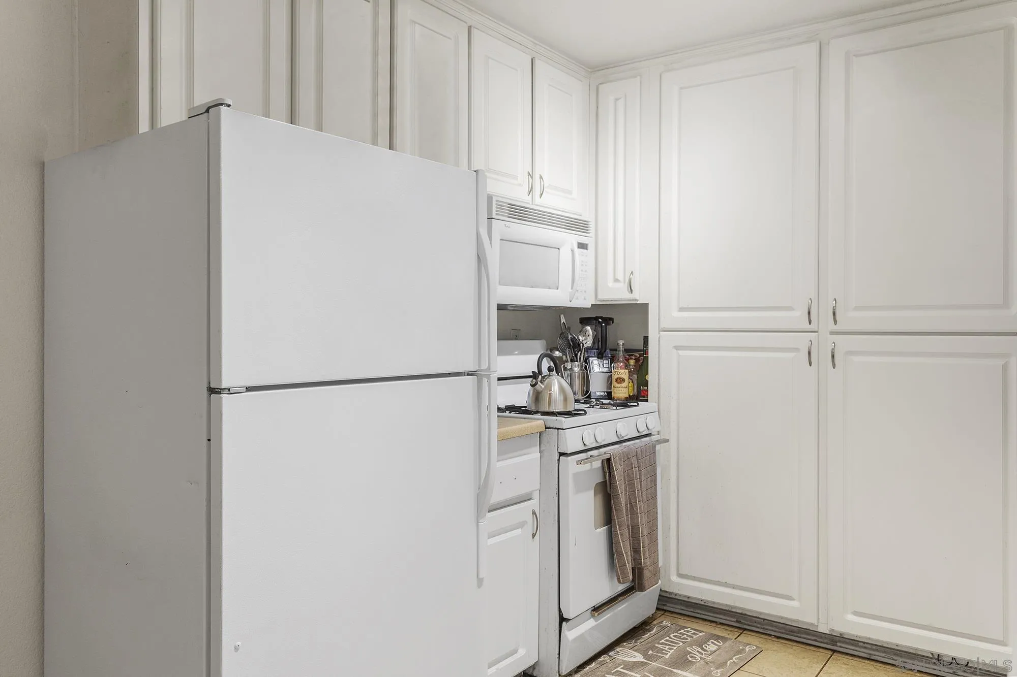 9041 Rosedale Drive, Unit A/B Spring Valley, CA 91977 - Photo 12 of 37 a white refrigerator freezer sitting in a kitchen