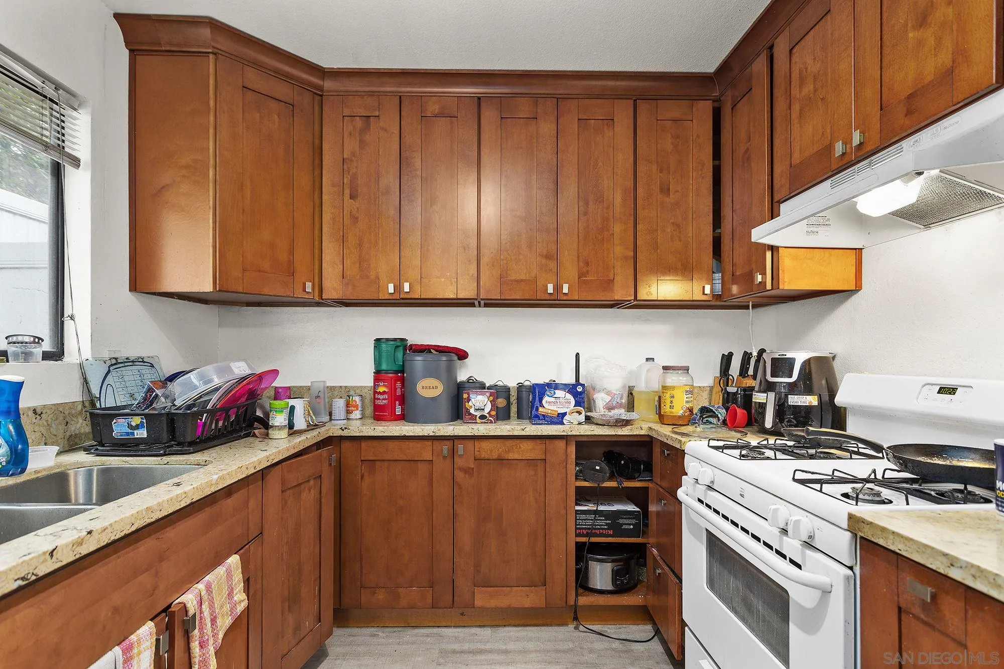 9041 Rosedale Drive, Unit A/B Spring Valley, CA 91977 - Photo 26 of 37 a kitchen with sink cabinets and appliances