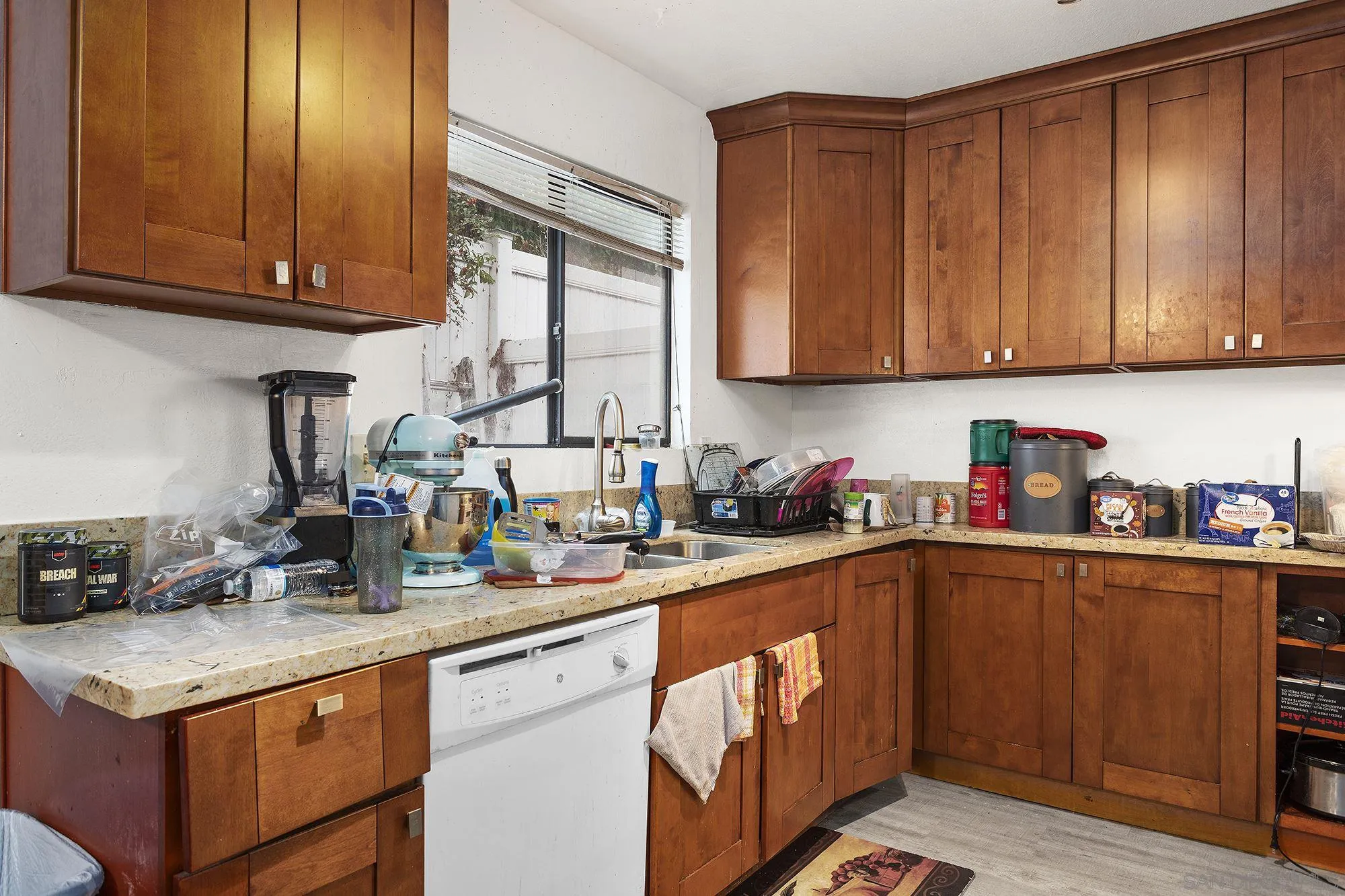 9041 Rosedale Drive, Unit A/B Spring Valley, CA 91977 - Photo 27 of 37 a kitchen with granite countertop a sink dishwasher stove and cabinets with wooden floor