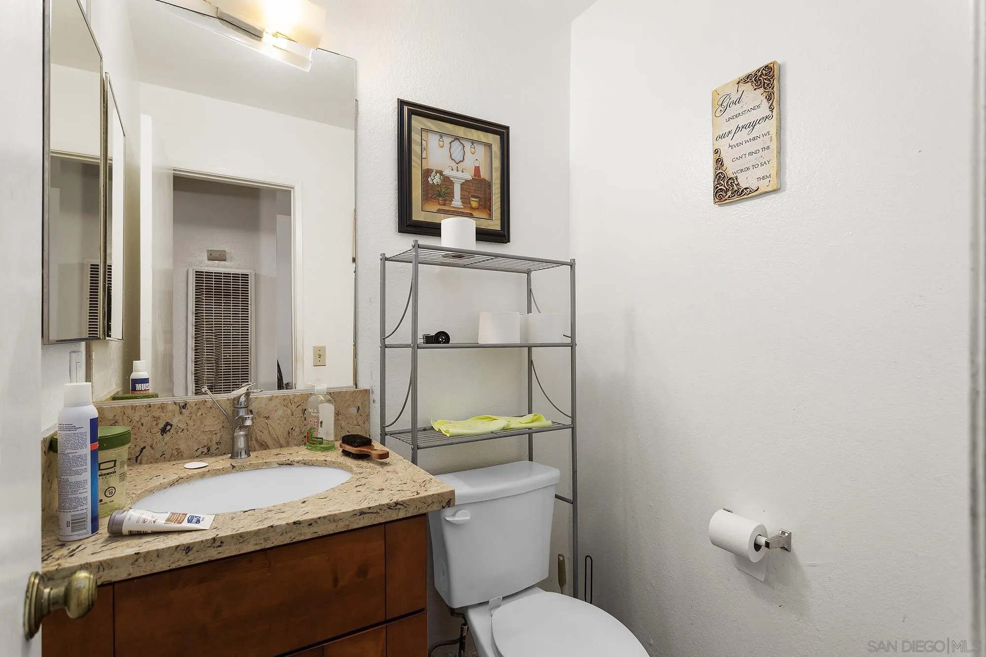 9041 Rosedale Drive, Unit A/B Spring Valley, CA 91977 - Photo 29 of 37 a bathroom with a granite countertop sink mirror vanity and toilet