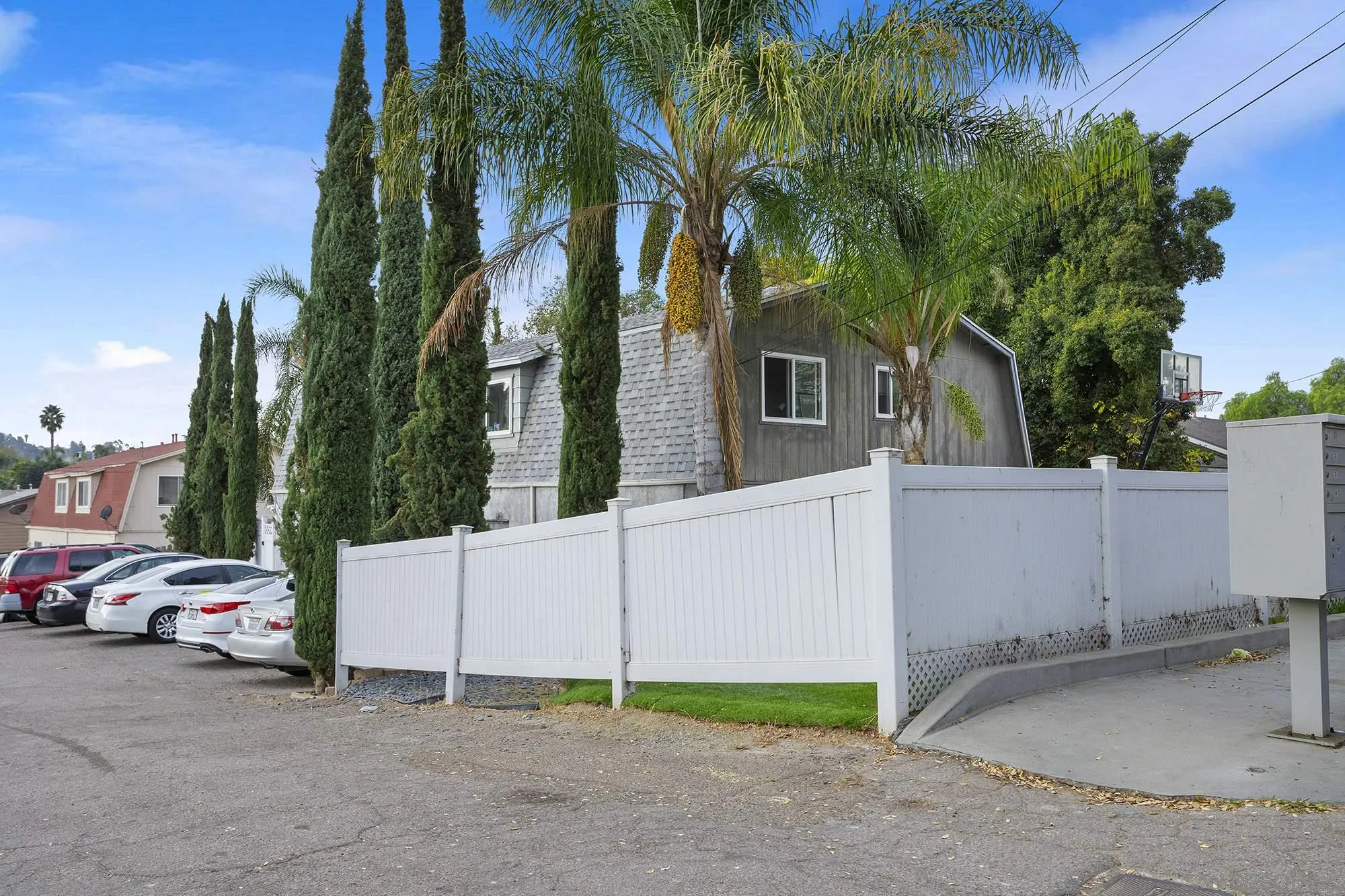 9041 Rosedale Drive, Unit A/B Spring Valley, CA 91977 - Photo 3 of 37 a view of a white house with a large tree and a yard