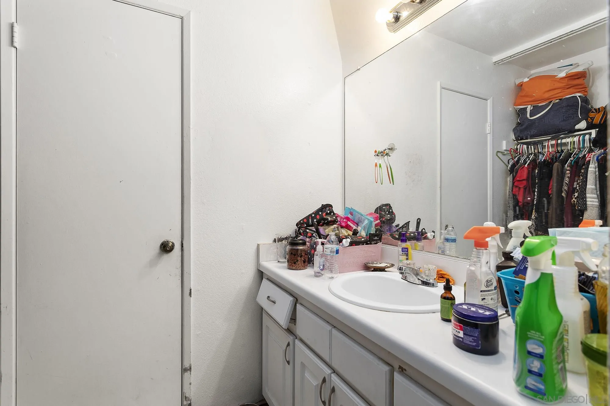 9041 Rosedale Drive, Unit A/B Spring Valley, CA 91977 - Photo 31 of 37 a bathroom with a sink and a mirror