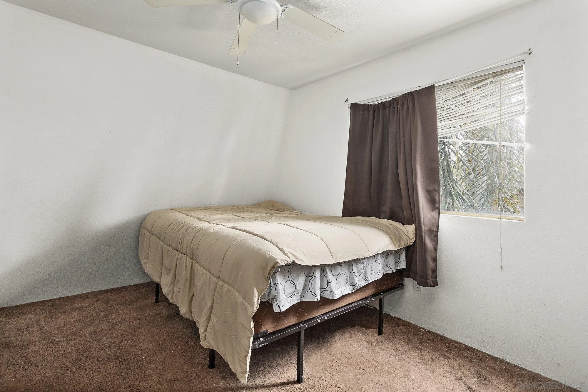 9041 Rosedale Drive, Unit A/B Spring Valley, CA 91977 - Photo 33 of 37 a bed sitting in a room next to a window