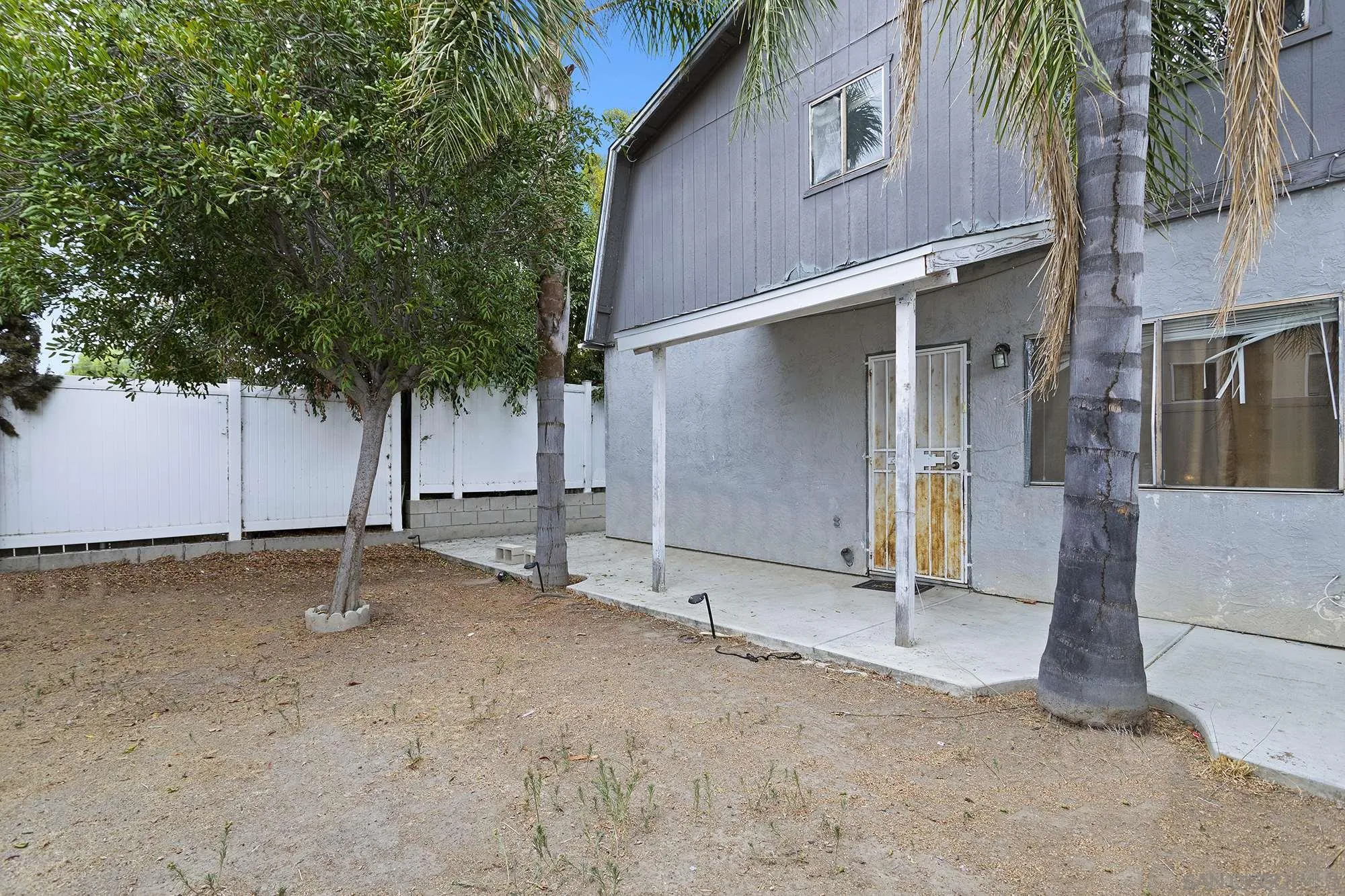 9041 Rosedale Drive, Unit A/B Spring Valley, CA 91977 - Photo 36 of 37 a backyard of a house with table and chairs