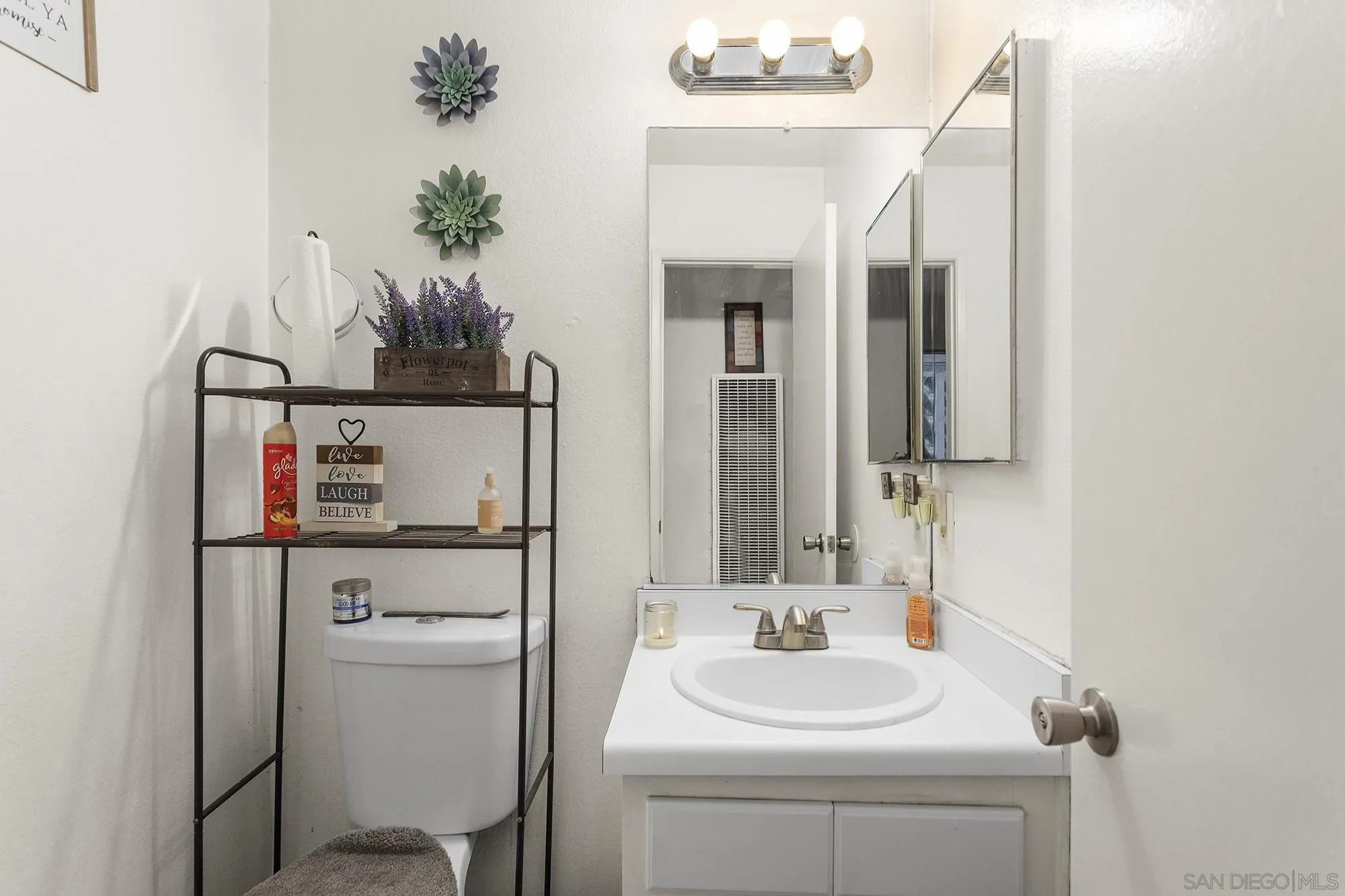 9041 Rosedale Drive, Unit A/B Spring Valley, CA 91977 - Photo 8 of 37 a bathroom with a sink a toilet and a mirror