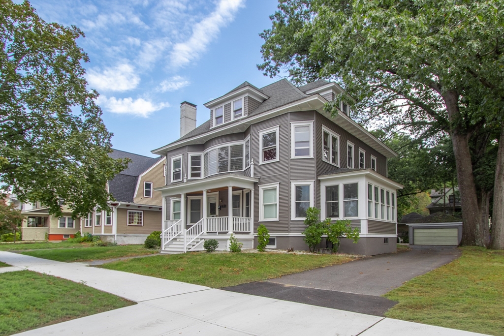 a front view of a house with a garden