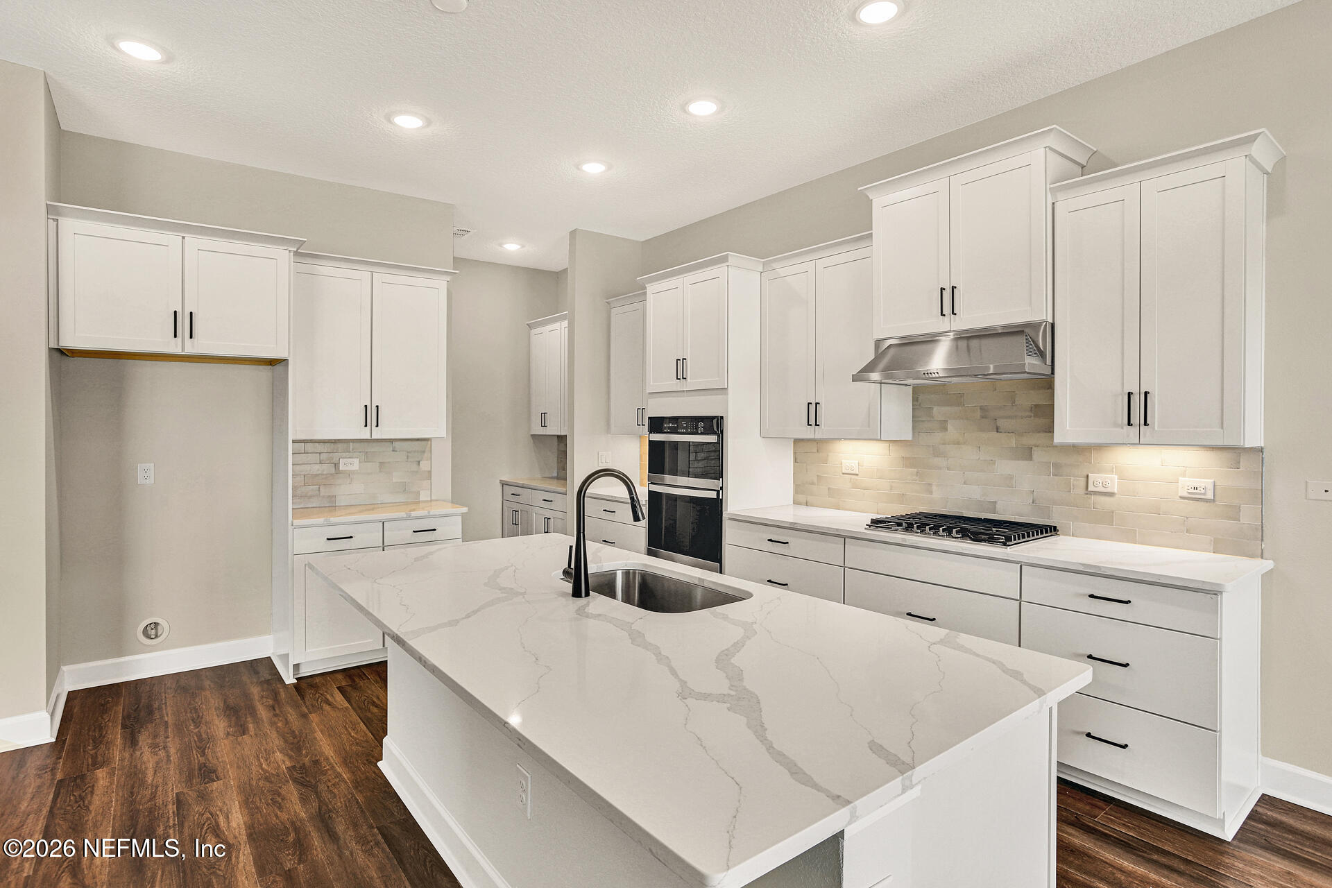 59 Ribera Drive Flagler Beach, FL 32136 - Photo 12 of 16 a kitchen with granite countertop white cabinets and white appliances