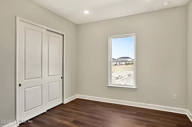 a view of kitchen with refrigerator and window