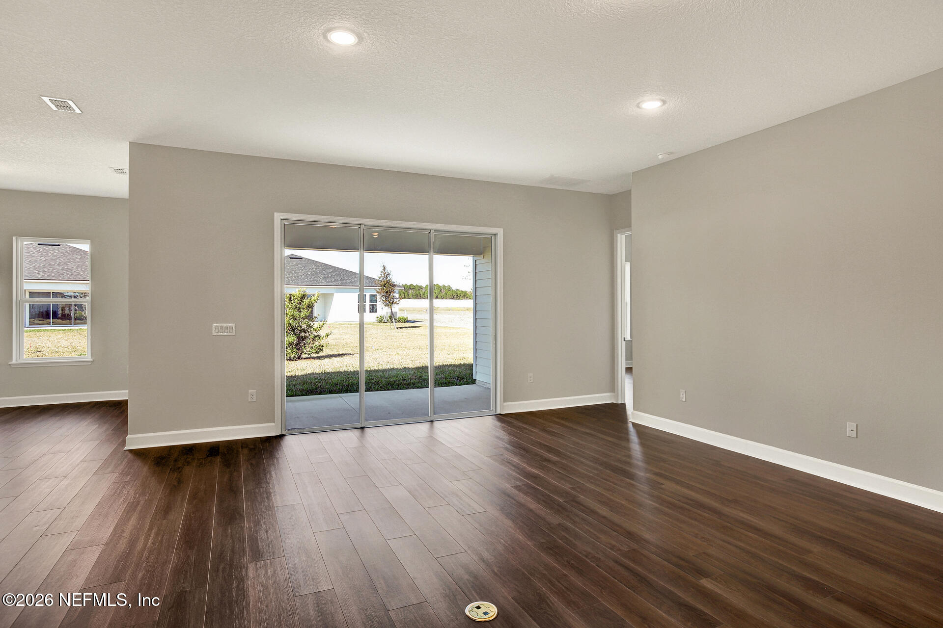 59 Ribera Drive Flagler Beach, FL 32136 - Photo 10 of 16 a view of an empty room with wooden floor and a window