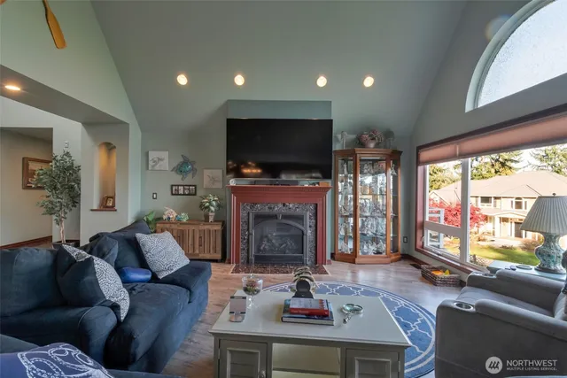 a living room with fireplace furniture and a flat screen tv