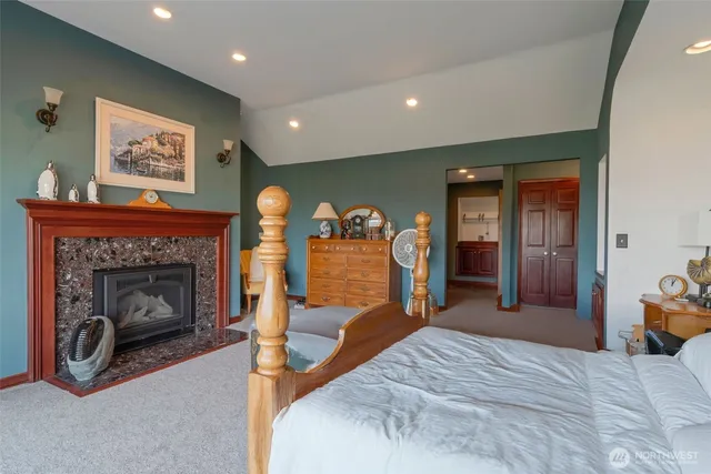 a bed room with a bed and a fireplace