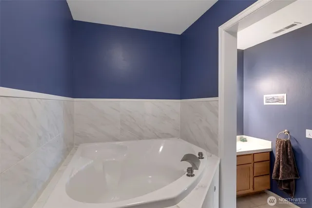 a bed sitting in a room next to a window