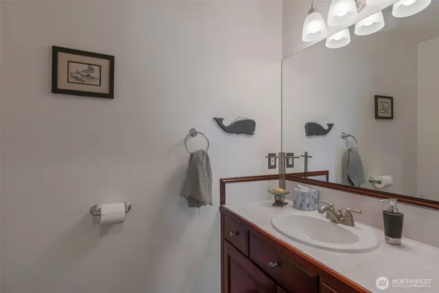 a view of a house with a big yard and large trees