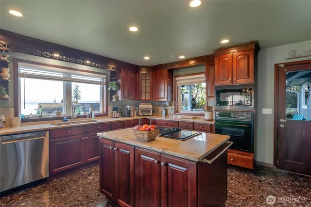 a kitchen with a stove a sink a refrigerator and wooden cabinets