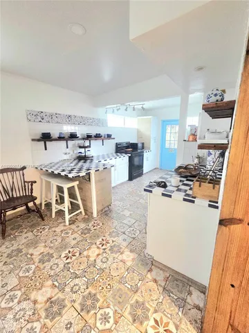 a kitchen with a stove a sink and a refrigerator