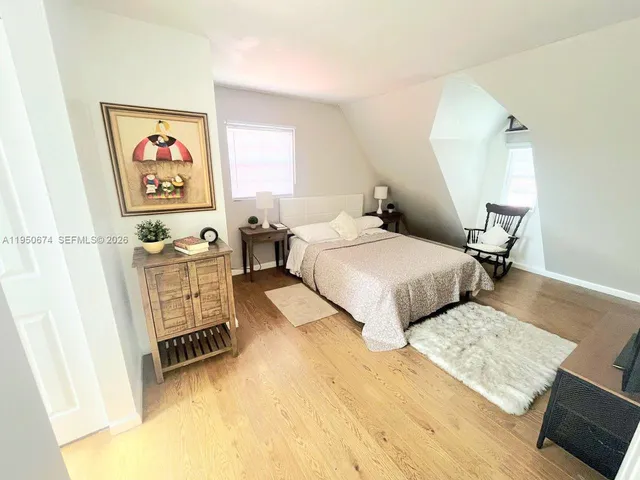 a bedroom with two beds and a desk
