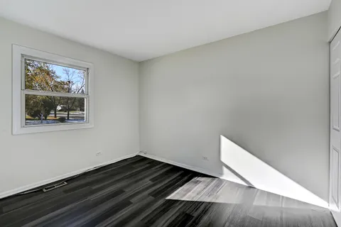 a view of an empty room and wooden floor