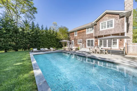 a view of a house with a backyard