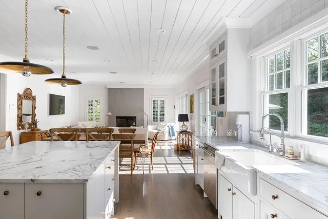 a view of living room with granite countertop couches with wooden floor