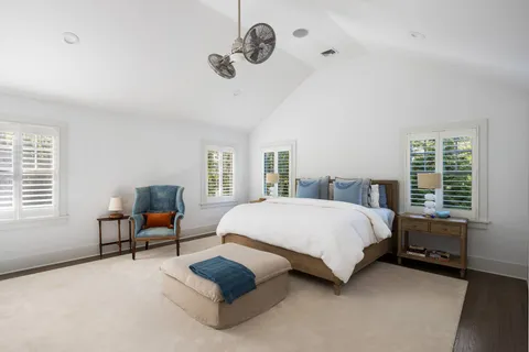 a spacious bedroom with a bed and a window