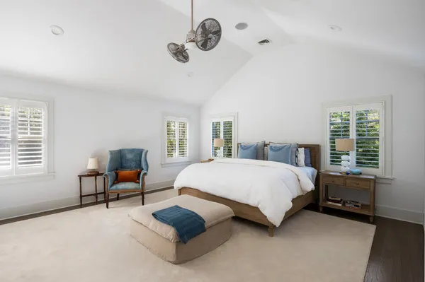 a spacious bedroom with a bed and a window