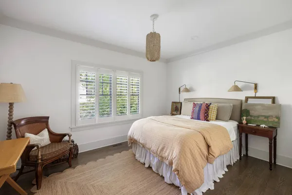 a bedroom with a bed and chair