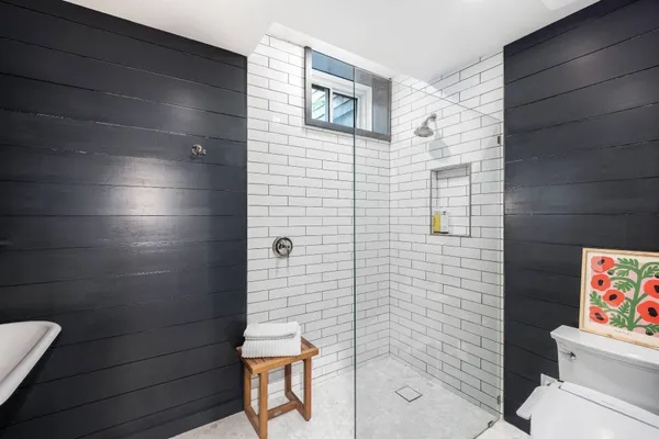 a bathroom with a toilet and a shower