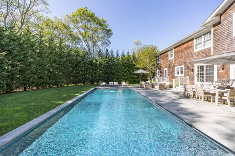 a view of a backyard with sitting area