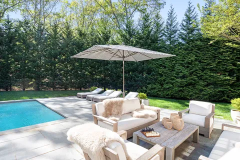 a view of backyard with outdoor seating barbeque oven and trees